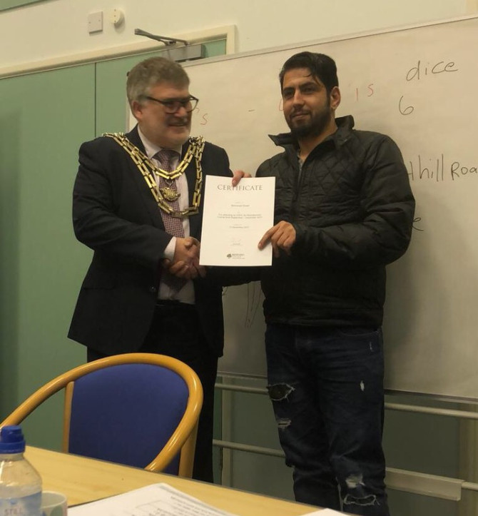 Mohamad Khater receiving his ESOL certificate from the Mayor